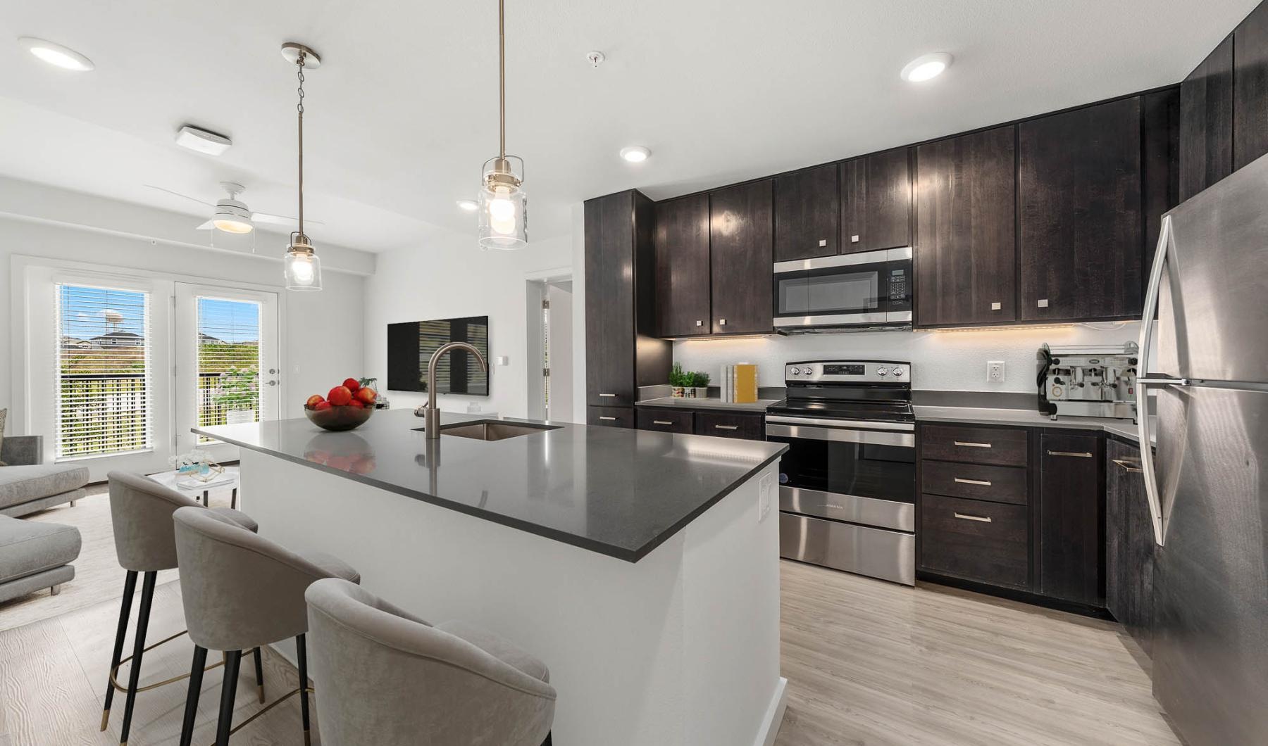 a kitchen with wood cabinets and stainless steel appliances